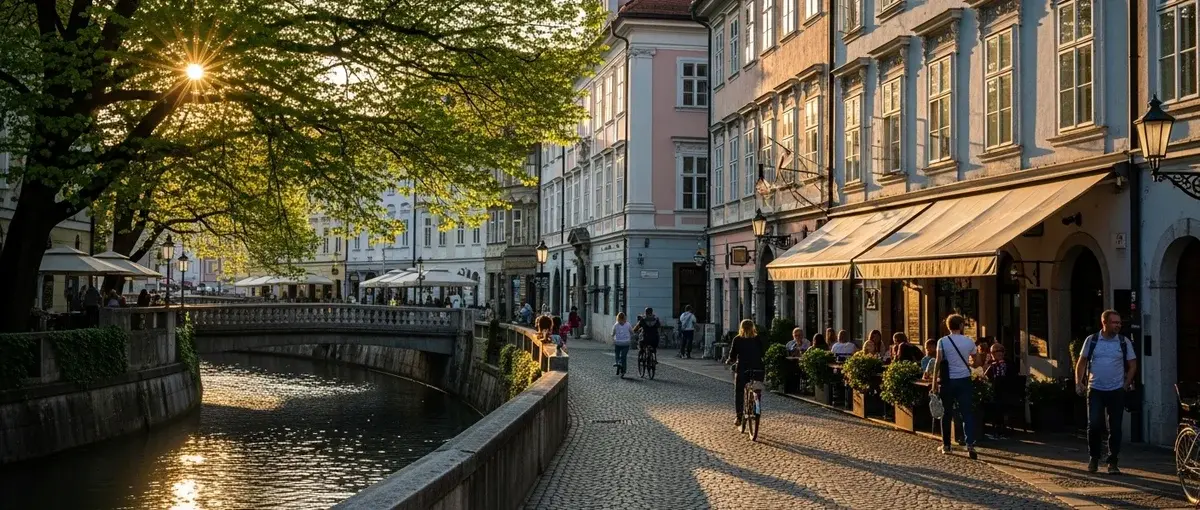 A charming, car-free street in Ljubljana, Slovenia, with pastel buildings and a river.